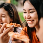 Asian,Students,Eating,Eating,The,Pizza,Together,In,Breaking,Time