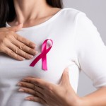 Closeup,Of,Pink,Badge,Ribbon,On,Woman,Chest,To,Support