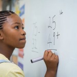 Portrait,Of,African,Girl,Writing,Solution,Of,Sums,On,White