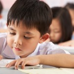 Group,Of,Students,Working,At,Desks,In,Chinese,School,Classroom