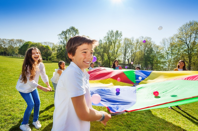Kids playing a parachute game