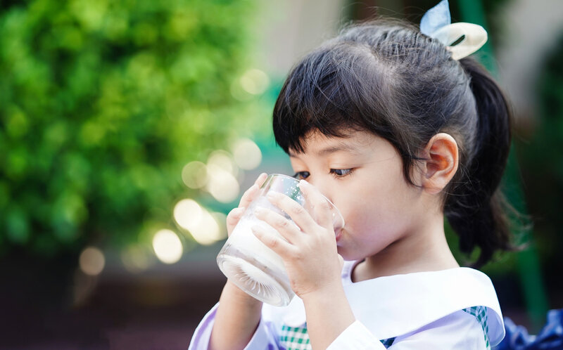 small girl drinking milk