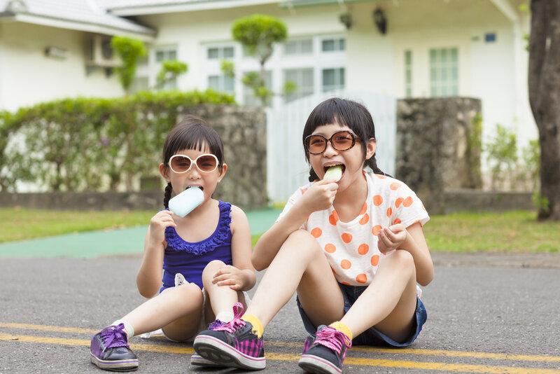 two young girls wearing ice cream