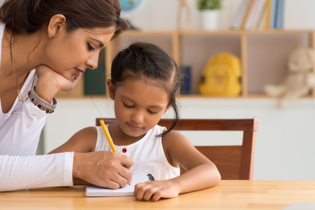 Mum helping child with their homework