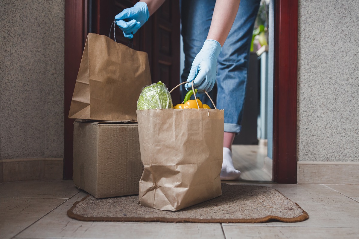 man holding bag of groceries