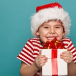 Little boy smiling with gift_Shutterstock