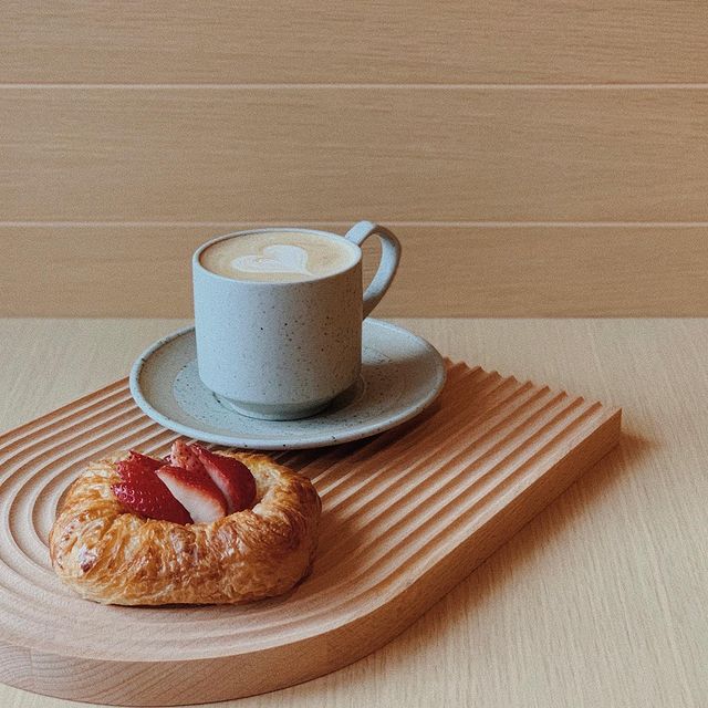 blue Coffee mug and croissant filled with strawberries