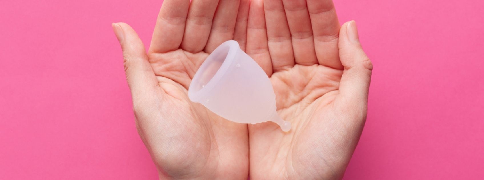 hands holding menstrual cup