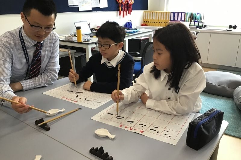 Students learning Chinese calligraphy at Wycombe Abbey School Hong Kong