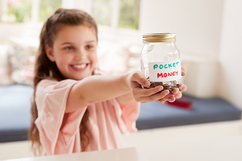 girl holding jar of pocket money