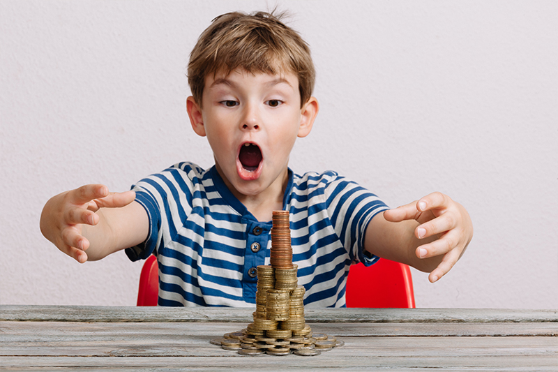 boy putting coins in a pile