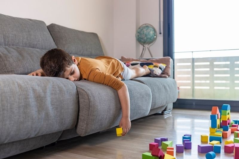 child lying on couch