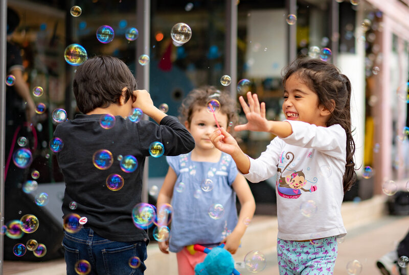 children playing in bubbles