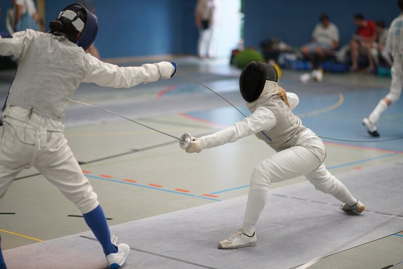 two girls taking fencing lessons