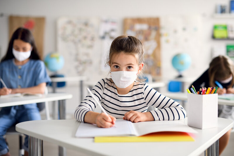 child with mask in class