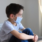 School,Boy,Wearing,Surgical,Face,Mask,Sitting,And,Home,During