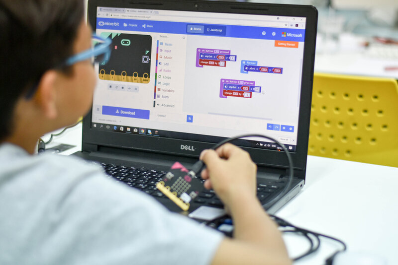 child coding on his laptop