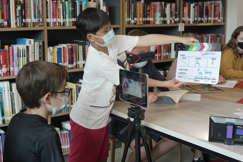 boy holding a clapperboard at babel film workshop
