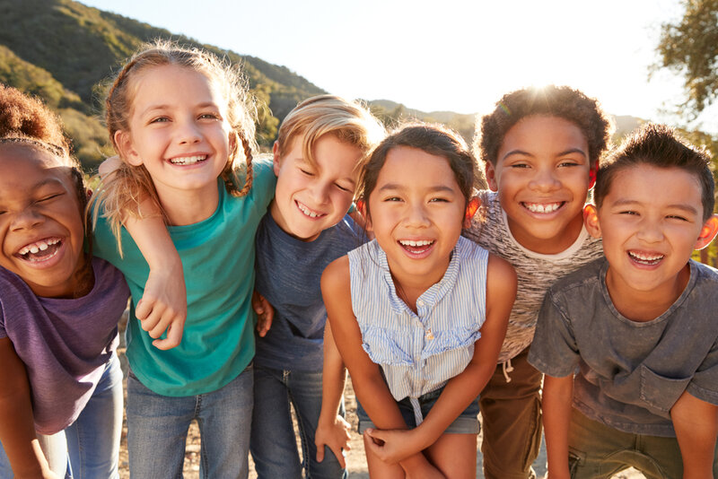 children smiling for portrait