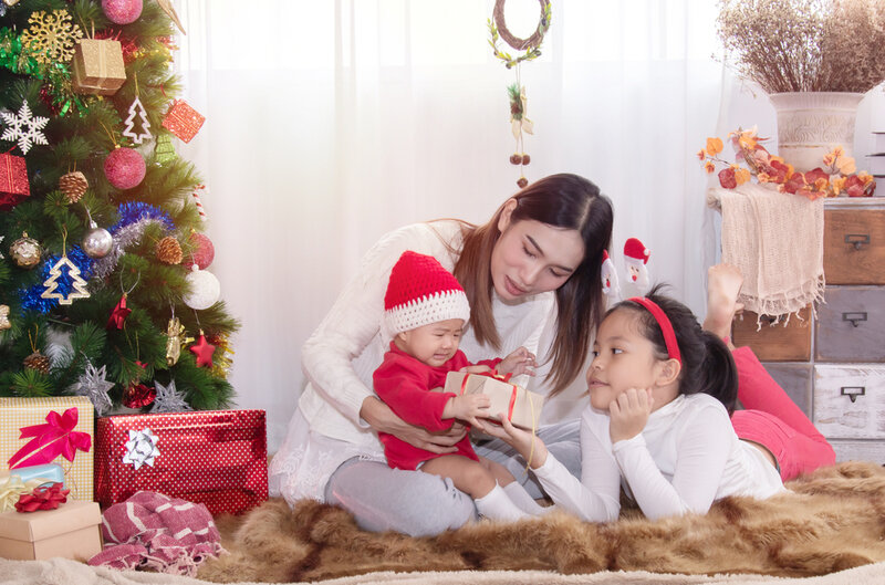 family giving baby christmas gifts
