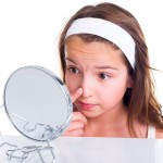Teen,Girl,Searching,For,Pimples,,Looking,In,The,Mirror