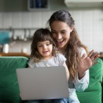 Happy,Mother,And,Kid,Daughter,Waving,Hands,Looking,At,Web