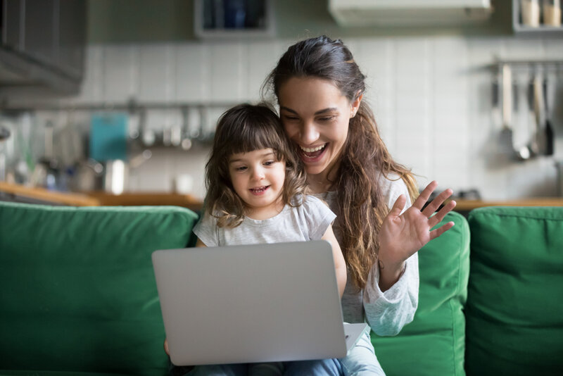 a mum and her daughter talking to their family over video this festive season