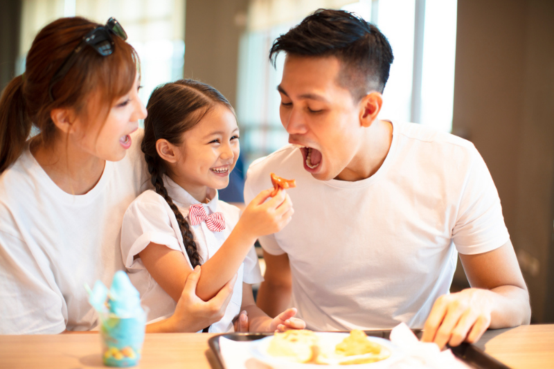 a family eating at a restaurant in hong kong