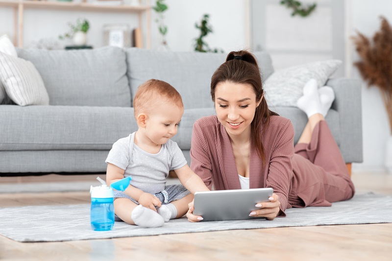 Mother and child playing on a tablet together