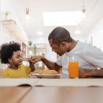 Portrait,Of,Happy,African,American,Father,And,Son,Hands,Fist