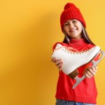 Little,Asian,Girl,In,Warm,Clothes,With,Ice,Skate,On