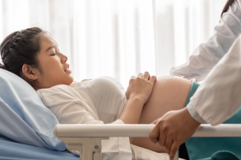 Asian woman giving birth