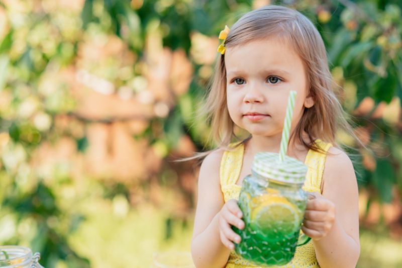 little girl drinking a fruit water